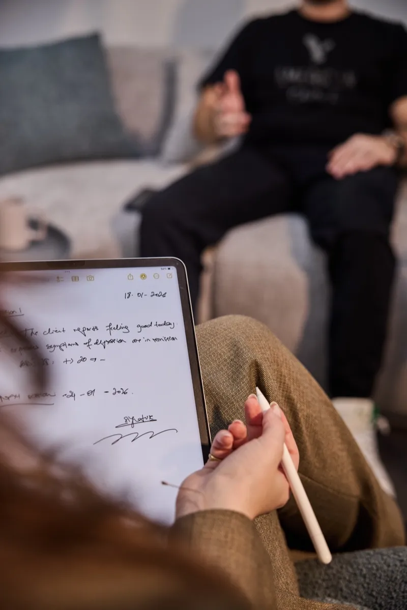 Psychology session with therapist taking notes